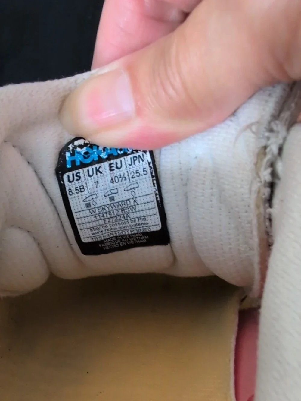 Hoka white blue shoe interior label